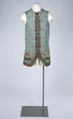 Waistcoat worn at the court of George III by Charles Cochrane Browne (1745-1825). Waistcoat is made from blue corded silk with a sprig designed woven brocade around the edges and down front enclosure. Two well pockets in front have printed pocket flaps. 14 buttons close the garment in the front.