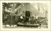 View of W. E. Brill and a boy, possibly his son, seated out front of the Camp Hutzler headquarters. Established by Albert and Joel Hutzler, of the Baltimore-based Hutzler's department store, the camp ran from 1921 to 1923. From July through September, employees of Hutzler's could go to the camp, located in the Patapsco Forest…