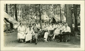 Group of people at Camp Hutzler. Established by Albert and Joel Hutzler, of the Baltimore, Maryland-based Hutzler's department store, the camp ran from 1921 to 1923. From July through September, employees of Hutzler's could go to the camp, located in the Patapsco Forest Preserve in Ellicott City, Maryland, and enjoy leisure time with their families.