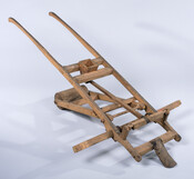 Corn planter with wooden wheel and metal plow. This device was patented on November 16, 1886.