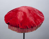 Lady's red velvet turban-style cap with a burgundy and gold woven band. From the personal effects of Elizabeth Patterson Bonaparte (1785-1879).