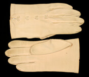 Pair of beige cotton cuff-length gloves with beige embroidered bows in a column on the forehand. From the personal effect of Mrs. A Curtis Bogert (nee Ada Campbell Simpson) (1899-1978).