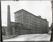 A view of the Doughnut Corporation of America factory building located in Ellicott City, Maryland. The factory was a flour mill and cereal plant that produced the Downyflake blend used in the production of doughnuts and was one of the area's primary employers. The Doughnut Corporation of America was founded after World War I by…