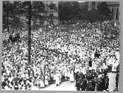 A large crowd of people holding American flags at Mount Vernon Place in Baltimore, Maryland, to welcome the arrival of the Marshal of France, Joseph Jacques Césaire Joffre, and the French Mission. Joffre visited the city as part of a French delegation touring the country after the United States entered World War I.