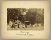 Approximately 25 figures at the horse track in Tolchester, Maryland. Several people are on horseback, while others watch from the stands. Tolchester was the site of the Tolchester Beach Amuseument Park, which consisted of a bathing beach, amusement park, racetrack, and hotel, and was in operation from 1877 to 1962. The Kent County park was…