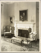 View of a fireplace and seating area in the Homewood estate. Homewood was built between 1801 and 1806 as a country home for Charles Carroll, Jr., son of Charles Carroll of Carrollton who was a signer of the Declaration of Independence. The Federal-period Palladian home was in the Carroll family until purchased by merchant William…