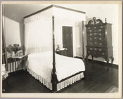 A bedroom in the Homewood estate, including a bed, highboy dresser, and bedside tables. Homewood was built between 1801 and 1806 as a country home for Charles Carroll, Jr., son of Charles Carroll of Carrollton who was a signer of the Declaration of Independence. The Federal-period Palladian home was in the Carroll family until purchased…