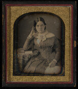 Daguerreotype portrait of an unidentified young woman posed with her head on her hand.