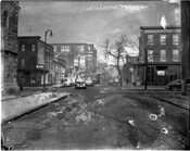 A view down the street looking northeast from the 500 block of West Lanvale Street towards the 1200 block of Druid Hill Avenue, Baltimore, Maryland. Shows the law office of Juanita Jackson Mitchell, Bethel A.M.E. Church on left, pedestrians, and automobiles.