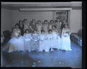 Portrait of a formally dressed group, possibly attending a wedding, with Verda Mae Freeman Welcome (1907-1990) seated at far left. Welcome was a public school teacher, civil rights activist, and one of the first Black women to be elected to a state senate in the United States.