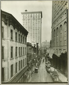 An elevated view looking west on Lexington Street from Charles Street in Baltimore, Maryland. On the right is a portion of the Fidelity Building built in 1894. O'Neil's department store is on the left, and the Baltimore Gas and Electric Company Building (constructed in 1916 and designed by the architectural firm of Parker, Thomas and…